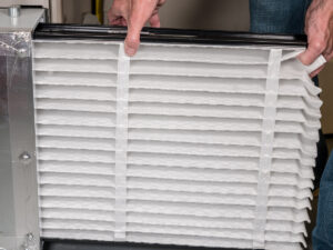 image of a technician removing an air filter.