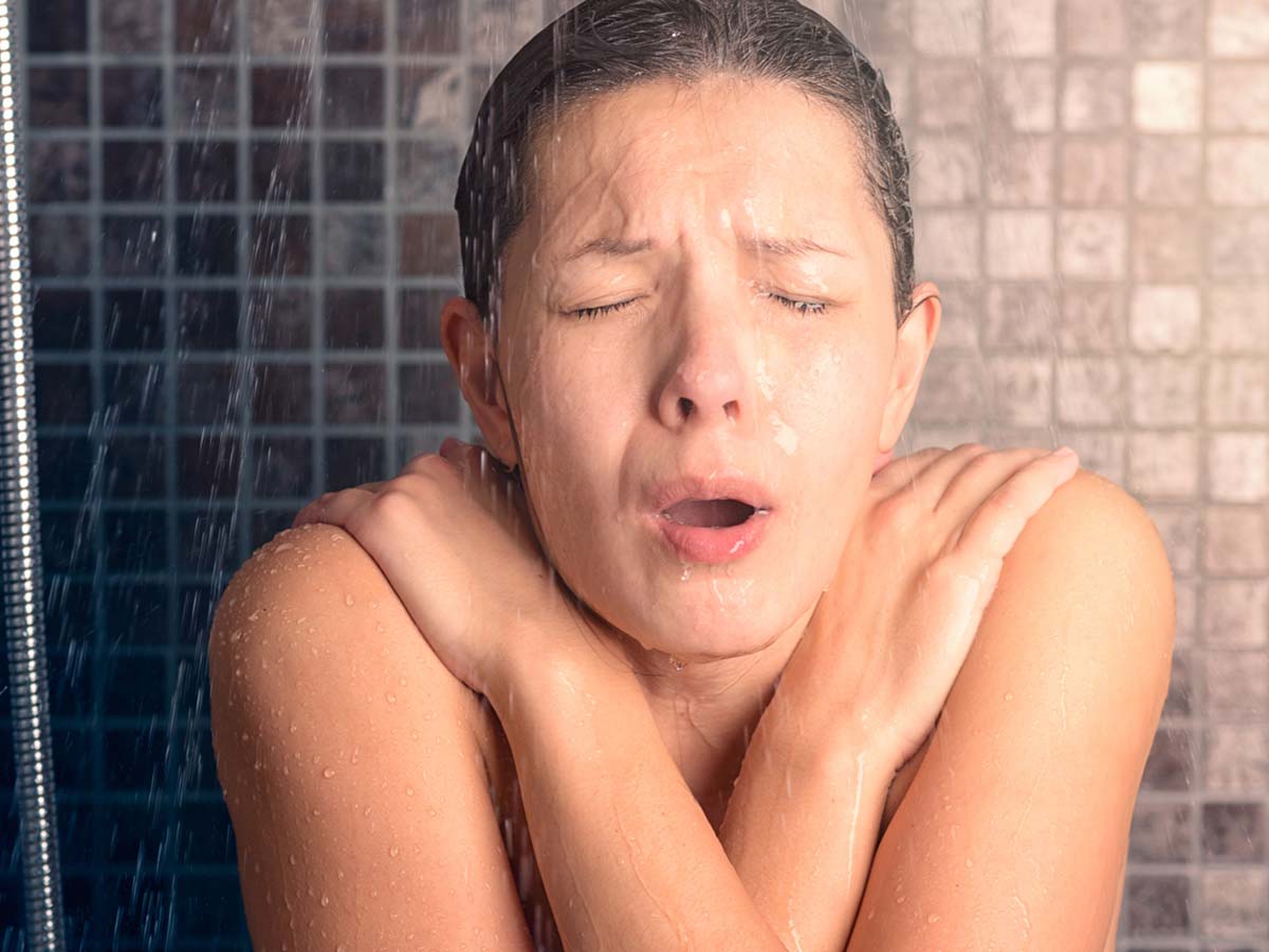 a woman in a freezing cold shower