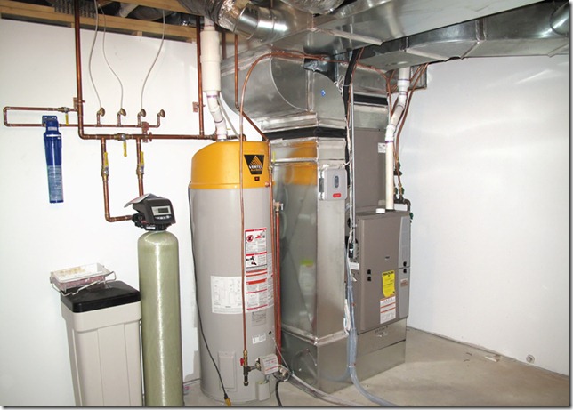 A residential HVAC system setup with a water heater, furnace, and various pipes and ducts.
